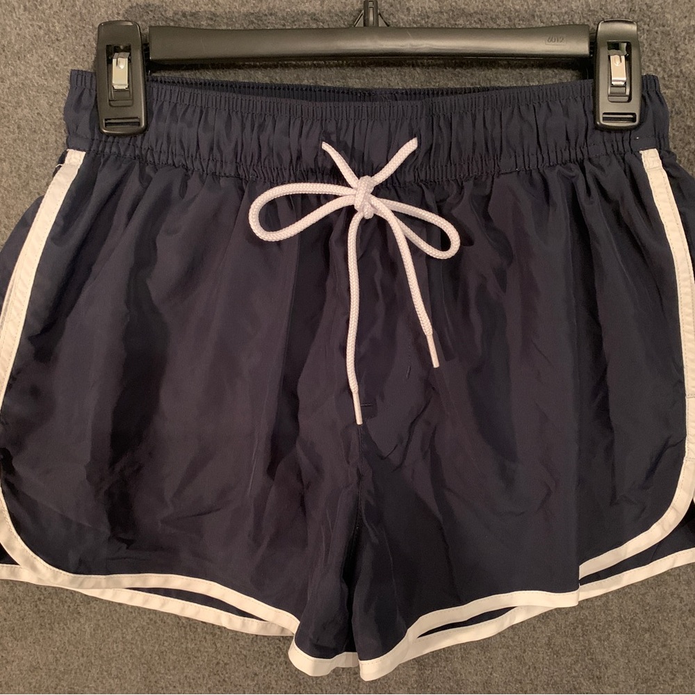 Blue H&M swim shorts with white trim.